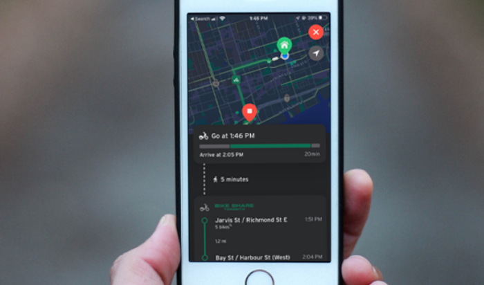 hand holding a phone that displays bike trip planning